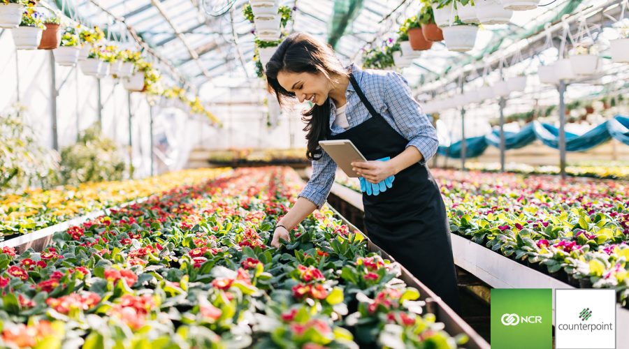 A woman taking inventory in her garden center.