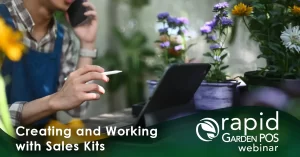 A man uses a tablet to create a sales kit within the robust Rapid Garden POS software in a garden retail setting. He is holding a pen and speaking on a phone while looking at a tablet. Surrounding them are colorful potted plants. Text: "Creating and Working with Sales Kits" -- a Rapid Garden POS webinar