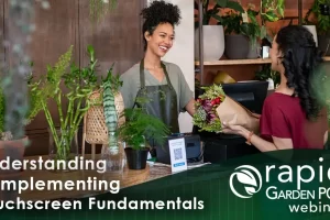 A smiling florist in an apron hands a bouquet of flowers to a customer at a counter. Various plants and flowers are displayed around them. Text: “Understanding & Implementing Touchscreen Fundamentals -- a Rapid Garden POS webinar